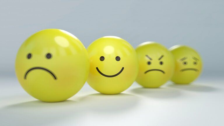 four yellow plastic balls with moody faces drawn on them